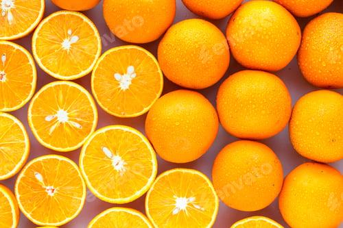 Preview: A Closeup Of A Pile Of Oranges Sliced And Whole