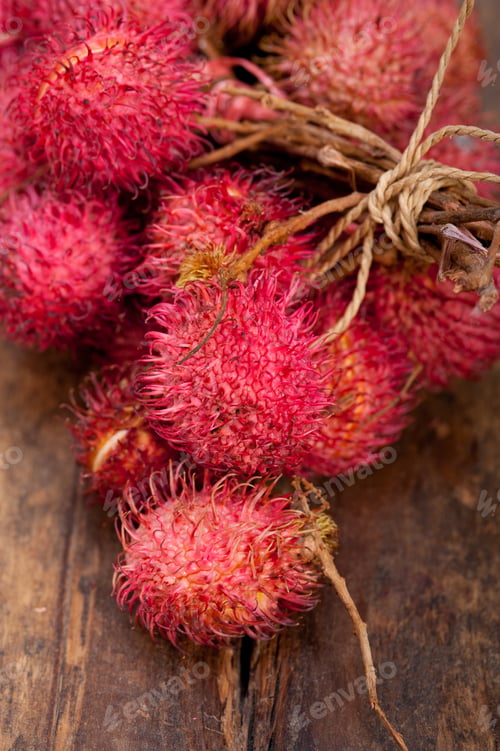 Preview: Fresh Tropical Rambutan Fruits Over Rustic Wood Table