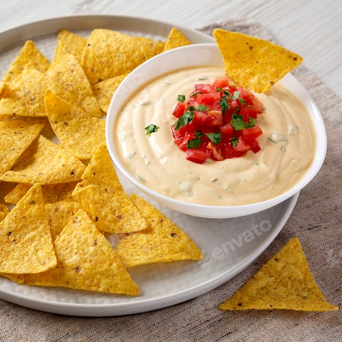 Preview: Homemade Cheesy Dip With Yellow Tortilla Chips On A White Wooden Background, Side View. Closeup.