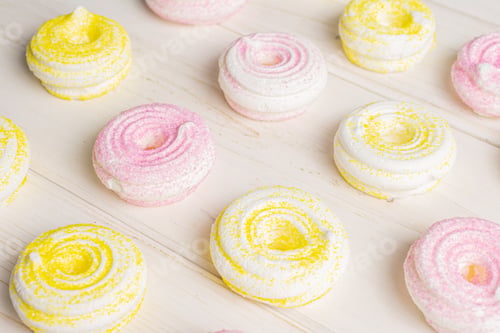 Preview: Lot Of Whole Pink And Yellow Sweet Meringue On White Wood