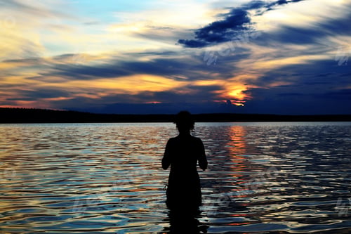 Preview: The Photo Of Summer Sunset On Lake With Silhouette Of A Girl In The Water