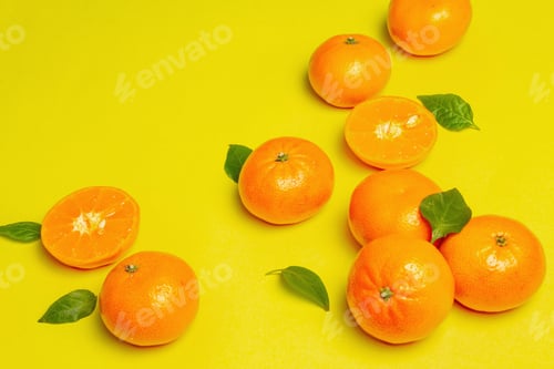 Preview: Ripe Juicy Tangerines And Fresh Leaves. Sunny Summer Yellow Background, Close Up