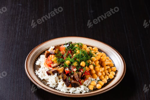 Preview: Rice With Chickpea And Vegetables On Wooden Table