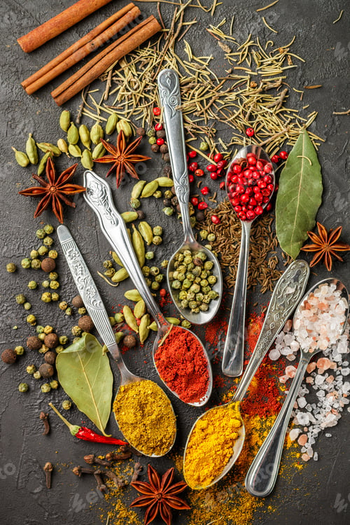 Preview: Variety Of Natural Spices, Seasonings And Herbs In Spoons On The Stone Table - Paprika, Curry