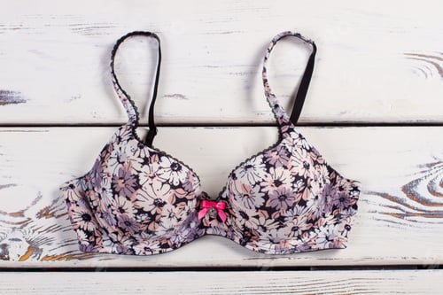 Preview: Beautiful Female Bra In A Floret On A Wooden Background.