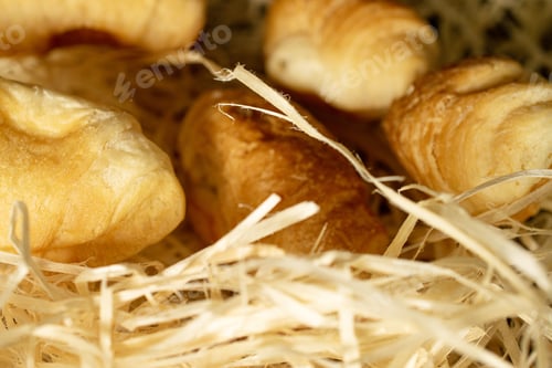 Preview: Group Of Five Whole Fresh Baked Mini Croissant Closeup On Straw Mat