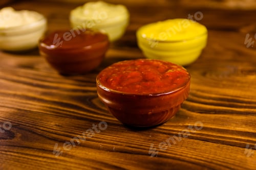 Preview: Different Sauces In Glass Bowls On Rustic Wooden Table