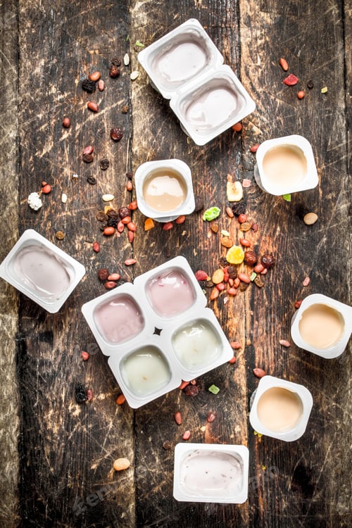 Preview: Various Fruit Yoghurts. On A Wooden Background.