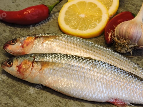 Preview: Mullet Lemon Garlic. Two Raw Fish And Garlic.