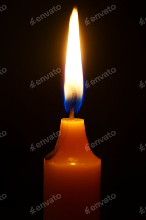 Preview: Burning Candle On A Black Background.