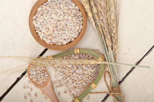 Preview: Organic Wheat Grains Over Rustic Wood Table Macro Closeup