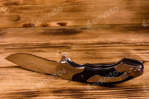 Preview: Opened Folding Knife On Rustic Wooden Table