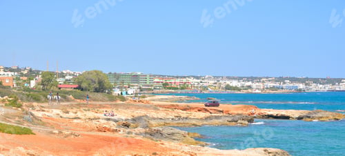 Preview: Rocks On The Shore Of The Sea And The City Of Hersonissos, Crete, Greece.