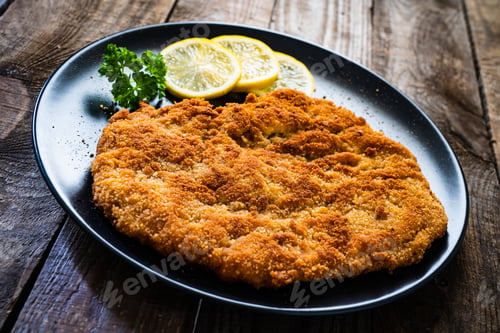 Preview: Schnitzel With Lemon On Wooden Background
