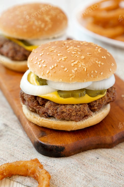 Preview: Homemade Mississippi Slug Burger With Onion Rings On A Rustic Wooden Board, Side View. Closeup.