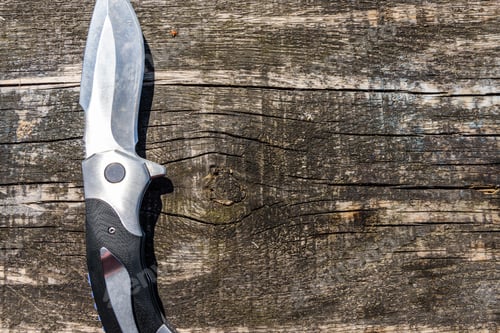 Preview: Survival Folding Knife On Rustic Wooden Background