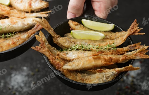 Preview: Fried Smelt In A Frying Pan On The Table With Spices, Lime And Thyme. Small Crispy Fish. Selective