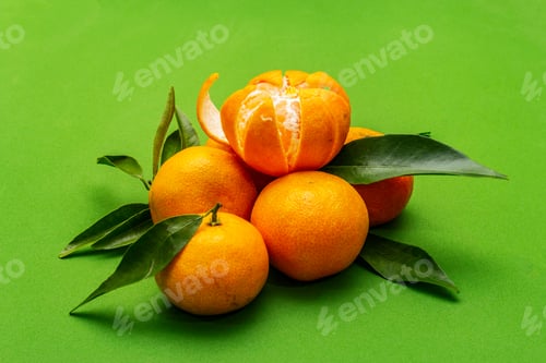 Preview: Ripe Tangerines With Leaves. Fresh Fruits Isolated On Green Background, Close Up