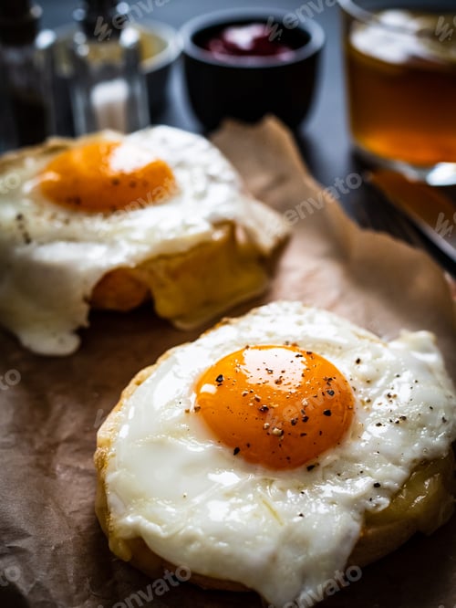 Preview: Continental Breakfast - Sunny Side Up Eggs On Baked Bun With Cheese And Vegetable Salad On Black