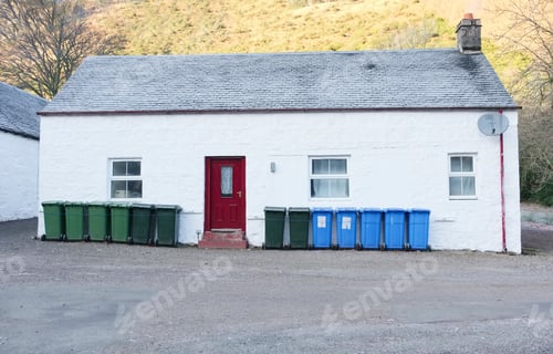Preview: Green And Blue Wheelie Bins In A Row On Street Outside House Waiting For Bin Men To Collect