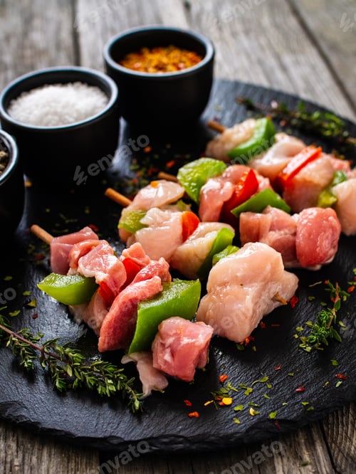 Preview: Uncooked Shashlik And Seasonings On Black Stone Board On Wooden Table