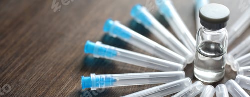 Preview: Ampoule And Needles From A Medical Syringe On Wooden Background