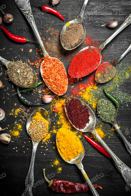 Preview: Ground Spices And Herbs In Spoons. On The Black Chalkboard.
