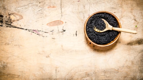 Preview: Black Caviar In A Bowl With A Wooden Spoon. On A Wooden Table. Free Space For Text . Top View
