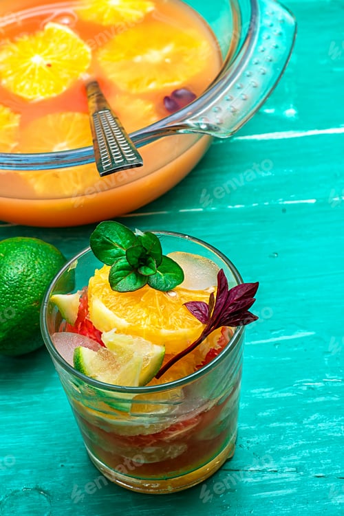 Preview: Glass Fresh Citrus Juice With Pulp On The Background Of The Vase With Juice