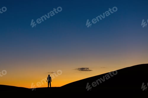 Preview: Sillhouette Of Man In Desert At Sunset