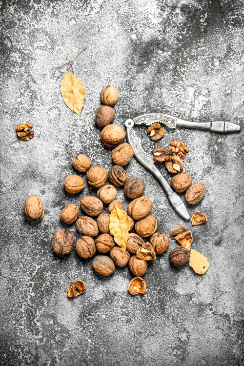 Preview: Walnuts With Nutcracker. On The Rustic Background.