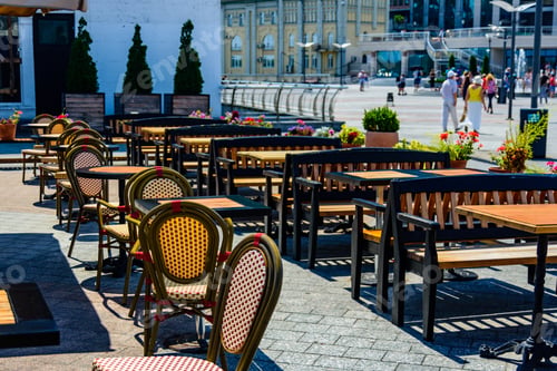 Preview: Chairs And Tables In Cozy Street Cafe