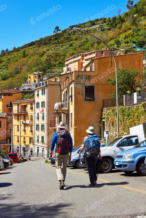 Preview: Happy Couple Of Tourists, A Man And A Woman With Backpacks Walk Through The Historical Part Of The