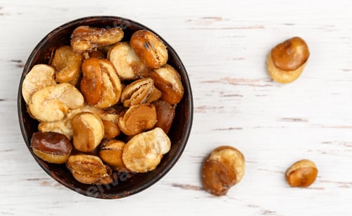 Preview: Crispy Fried Broad Beans With Salt In A Bowl Close-Up On A White Wooden Table. Beer Snack. Vicia