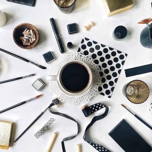 Preview: Flay Lay Workspace Home Office With Black Coffee Mug, Sketchbook, Napkins, Ribbons, Paintbrushes On