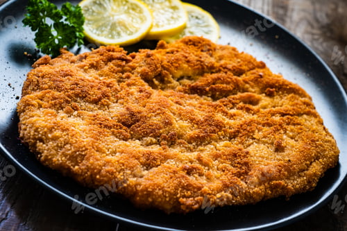 Preview: Schnitzel With Lemon On Wooden Background