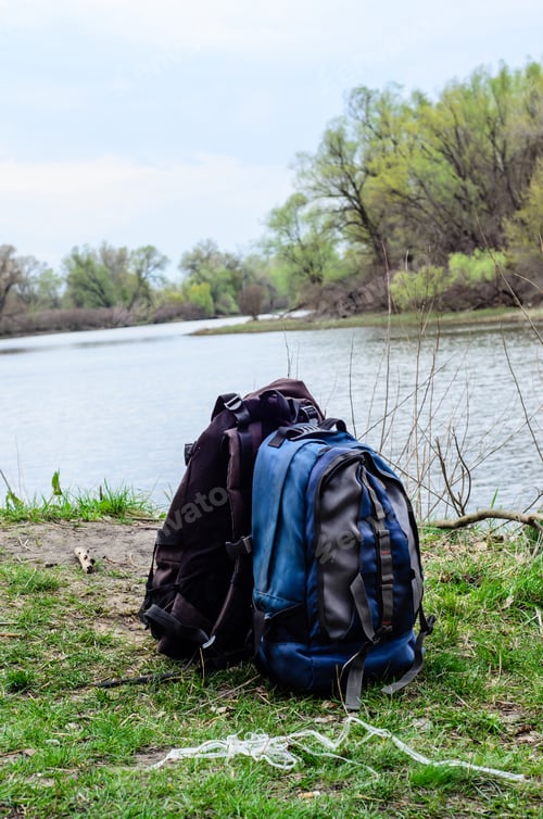 Preview: Backpacks On A Green Bank Of The River