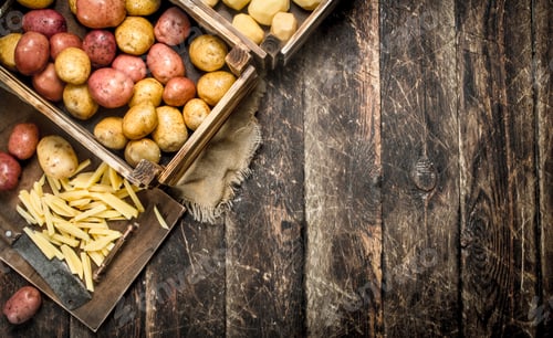 Preview: Sliced Fresh Potatoes With An Old Hatchet. On A Wooden Background.