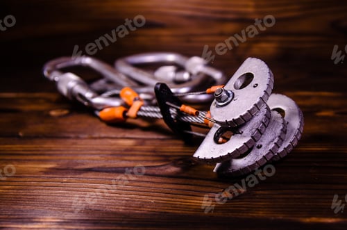 Preview: Camming Device Friend And Carabines For Rock Climbing On Rustic Wooden Table