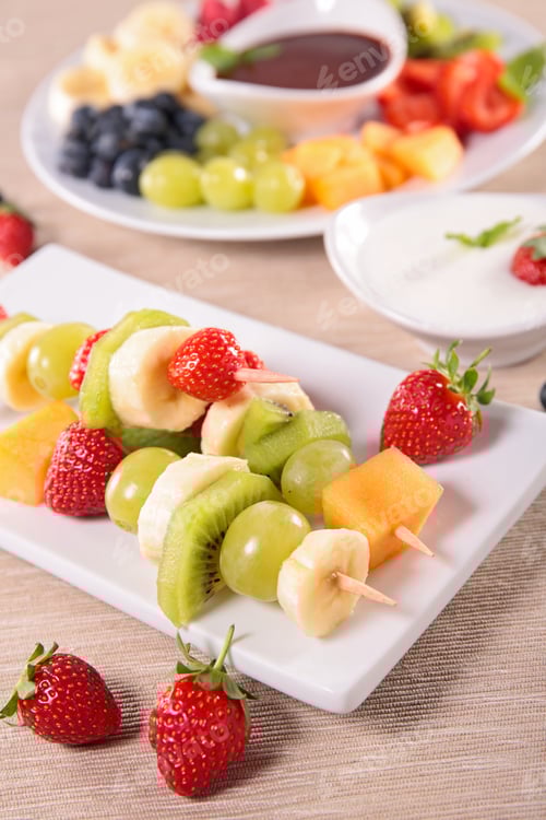 Preview: Colorful Fruit Skewers with Dipping Sauces on Table