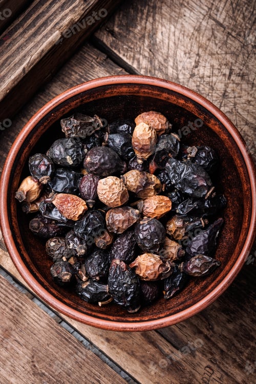 Preview: Dried Red Rose Hips In Bowl On A Wooden Rustic Table