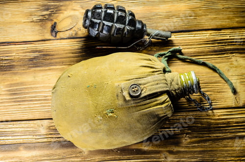 Preview: Army Flask In Rag Khaki Cover And Hand Grenade On Wooden Table