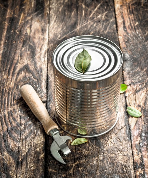 Preview: Food In Tin Can With Opener. On A Wooden Background.
