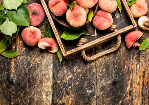 Preview: Ripe Peaches On A Tray. On A Wooden Background.
