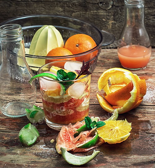 Preview: Fresh Juice Of Tropical Citrus Fruits On Wooden Background.Selective Focus