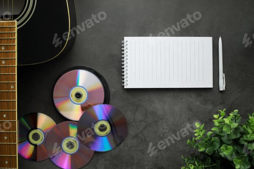 Preview: Guitar And Accessories On A Stone Background. Desk Musician, Headphones, Microphone And More.