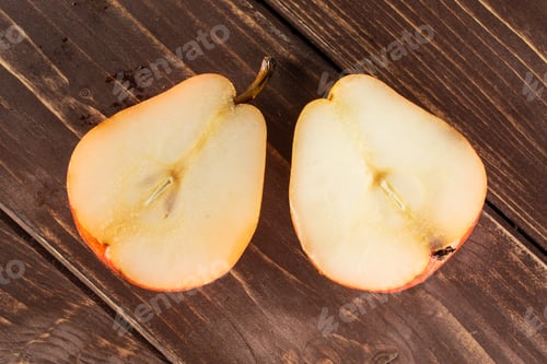 Preview: Group Of Two Halves Of Fresh Red Pear Flatlay On Brown Wood