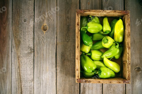 Preview: Pepper In A Box On A Wooden Background.