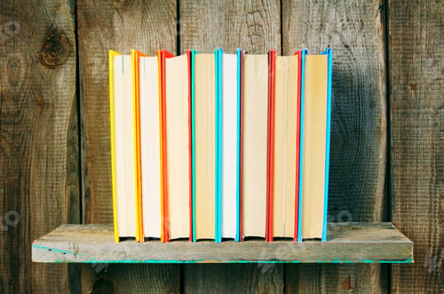 Preview: Books On A Wooden Shelf. On A Wooden Background.
