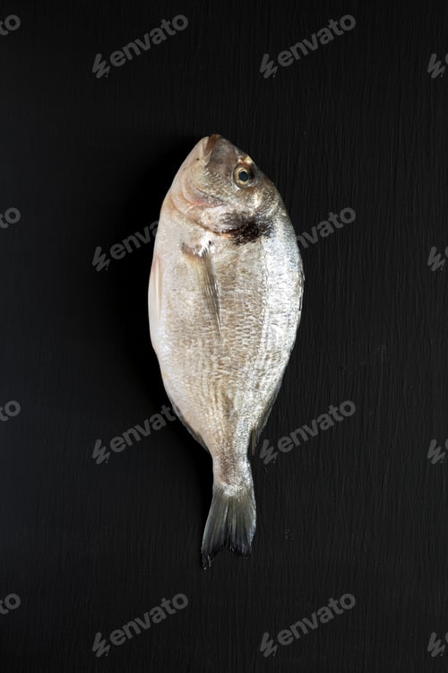Preview: Fresh Dorado Fish On Dark Wooden Background, Overhead View. Flat Lay, From Above, Top View.